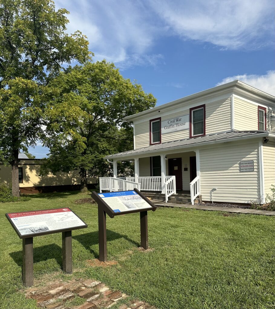 outside view of the Graffiti House with two historical signs out front