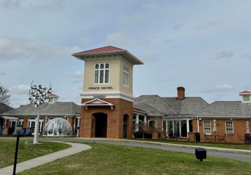 A brick building with a central tower labeled 