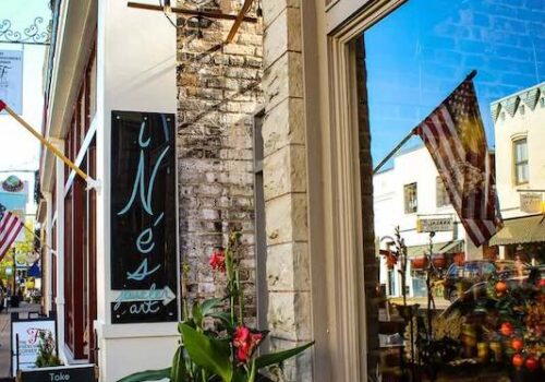A charming storefront with a brick exterior, displaying a sign that reads 