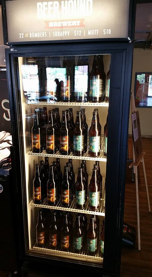 Refrigerator filled with 22 oz beer bottles from 