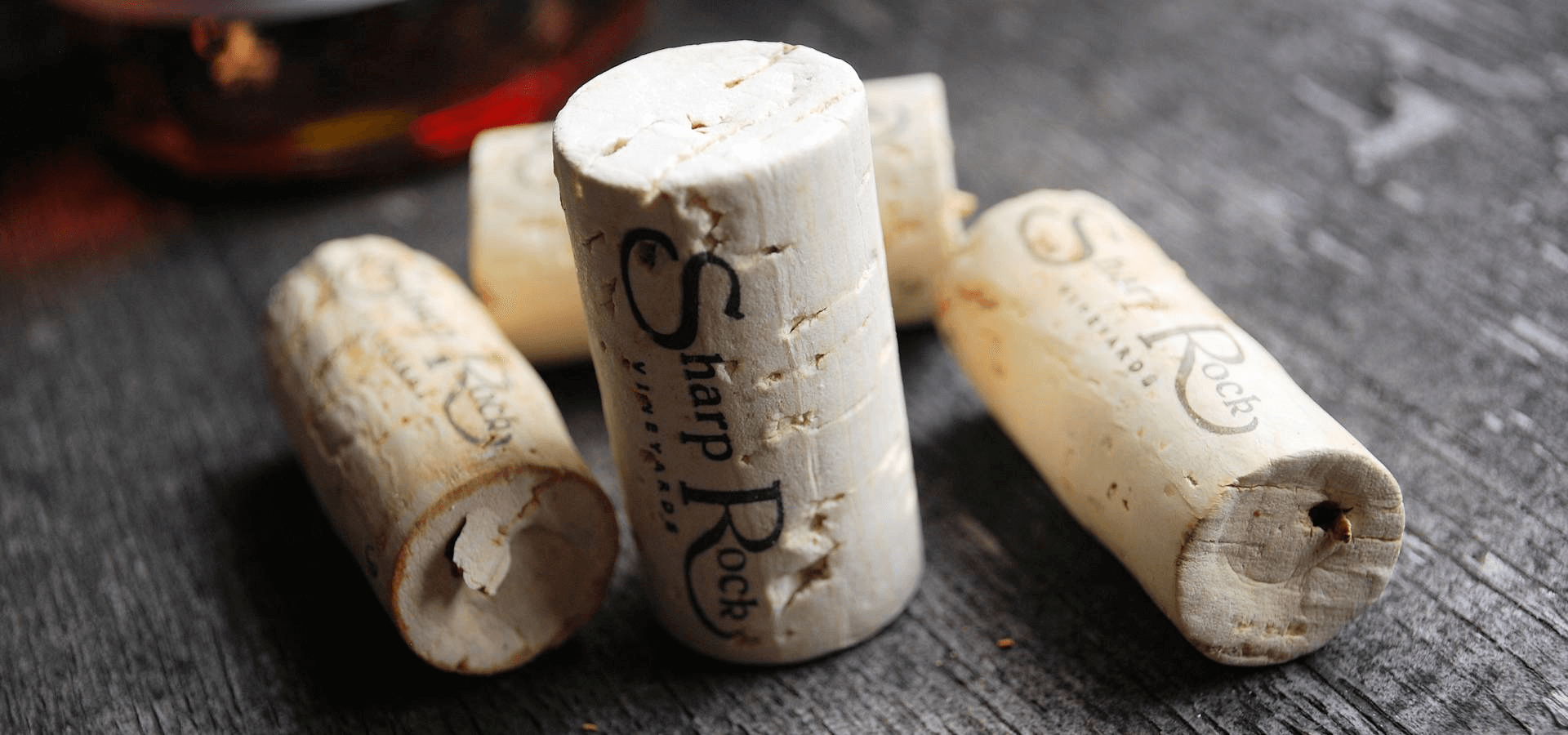 Five wine corks labeled 