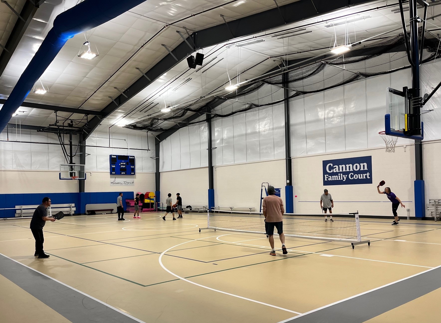 group of people playing pickleball