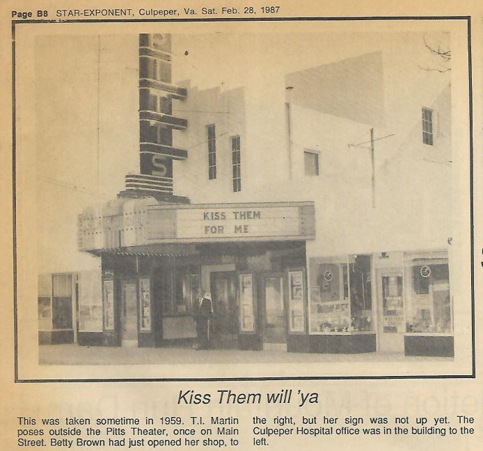 A sepia-toned image taken in 1959 showing T.I. Martin posing outside the Pitts Theater on Main Street. The theater marquee reads "Kiss Them for Me." Nearby, Betty Brown's unopened shop and the yet-to-be built Culpeper Hospital office are also visible.