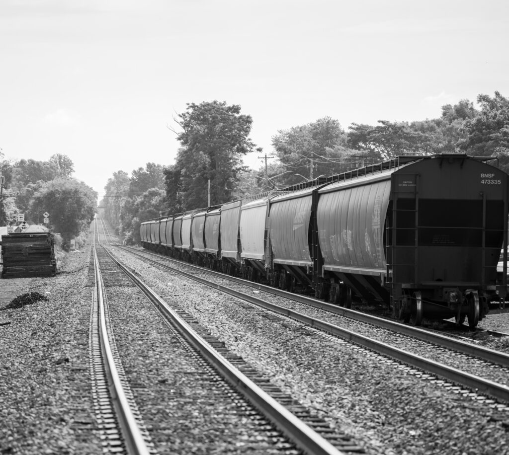 black and white image of rail cars on railroad tracks