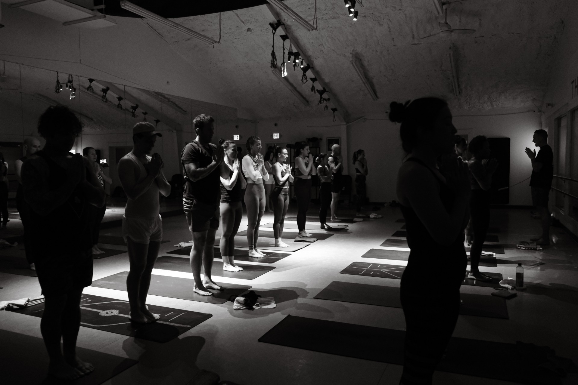 black and white photo of a group of people doing yoga