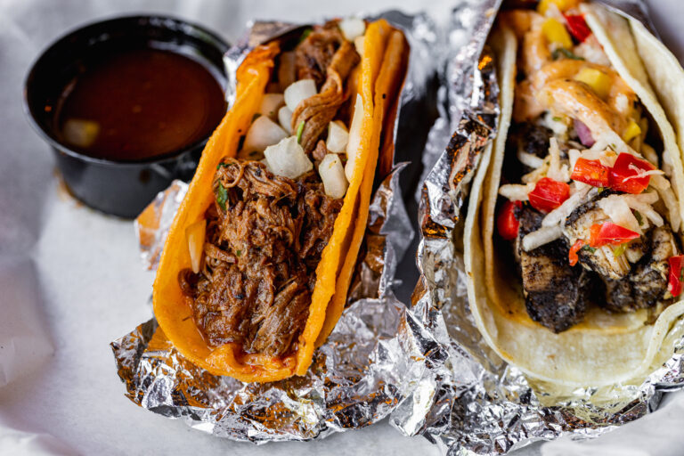 two tacos wrapped in aluminum foil