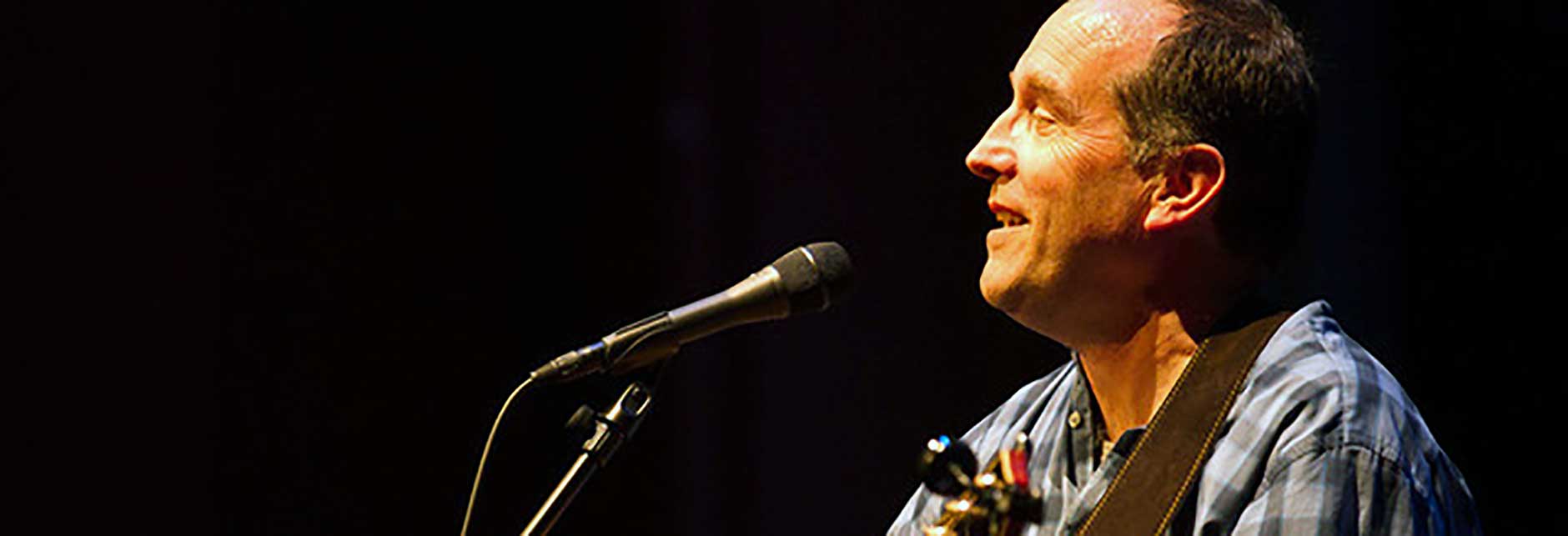 man singing into a microphone